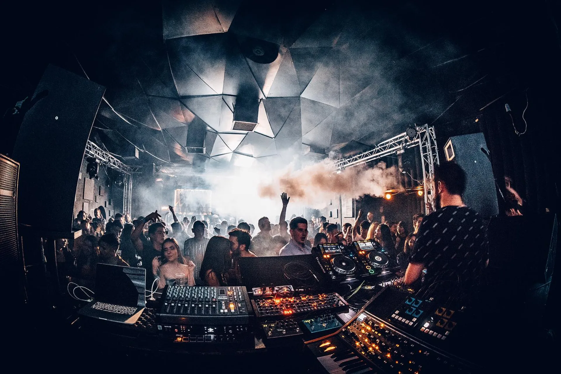 The dance floor seen from the booth under the geometric club ceiling